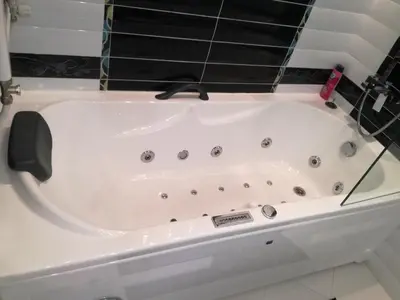 a white bath tub in a bathroom at Apartment 33 in Hotel Iceberg in Borovets