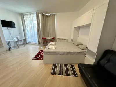 a bedroom with a bed and a couch in it at Luxury apartments in St. John Park in Bansko
