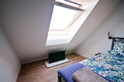 a bedroom with a bed and a large window at Apartment City View in Sofia