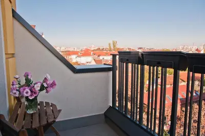 a vase of flowers sitting on a balcony at Apartment City View in Sofia