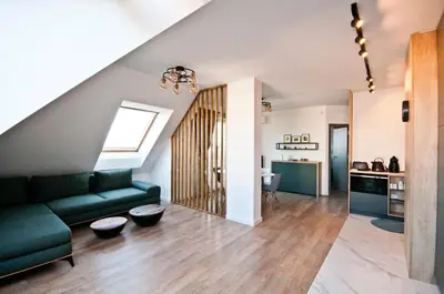 a living room with a green couch and a kitchen at Apartment City View in Sofia