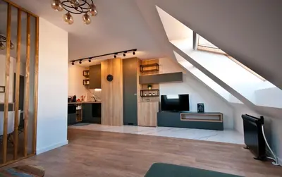 an attic living room with a skylight at Apartment City View in Sofia