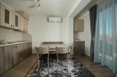 a kitchen with a table and chairs in a room at Къща за гости Елица in Starchevo