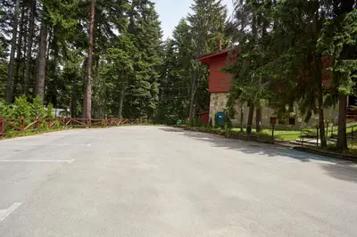 an empty road in front of a red building at Хотел 