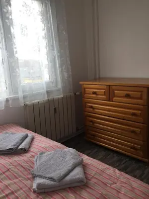a bedroom with a bed and a dresser and a window at Faith,Hope and Love apartment in Sofia