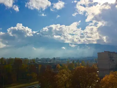 a view of a city with clouds in the sky at Faith,Hope and Love apartment in Sofia