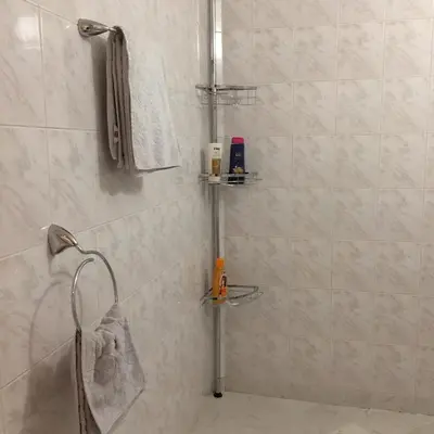 a bathroom with a shower with white tiled walls at Faith,Hope and Love apartment in Sofia