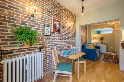 a living room with a brick wall and a table at FUNKY FRESH place in the heart of Sofia in Sofia