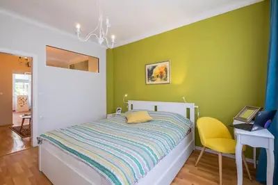 a green bedroom with a bed and a yellow chair at FUNKY FRESH place in the heart of Sofia in Sofia