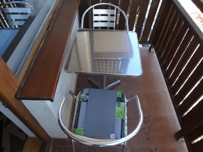 a chair sitting on top of a balcony at Simon's studio in Bansko