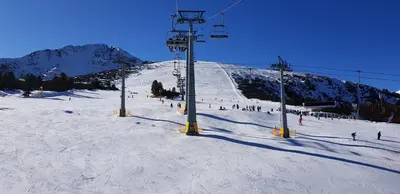 a group of people on a ski slope with a ski lift at Simon's studio in Bansko