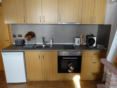 a small kitchen with a sink and a stove at Simon's studio in Bansko