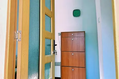 a door in a room with a cabinet and a mirror at Нouse with cute little yard in Plovdiv