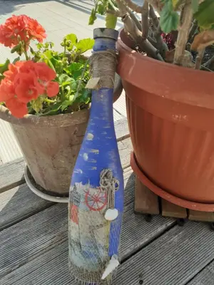 a blue bottle sitting next to a potted plant at Alexander Hotel in Asenovgrad