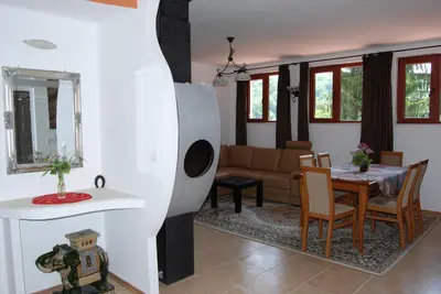 a living room with a table and a couch at Vidima Apartment Hotel in Apriltsi