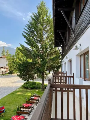 a row of tables and chairs on a balcony at Edelweiss Central Hotel in Bansko
