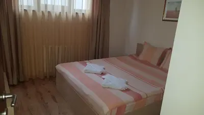a bedroom with two beds with towels on them at Borovets Gardens Apartments TMF in Borovets