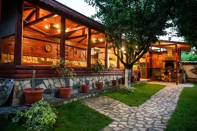 a house with potted plants in front of it at Medi Guest House in Sapareva Banya