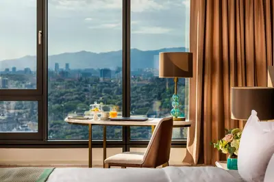 a hotel room with a table with a view at Grand Hotel Millennium Sofia in Sofia