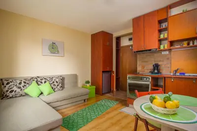 a living room with a couch and a table at Green Lime Studio in Bansko