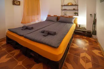 a bed with two brown slippers on top of it at Central Halls apartment in Sofia