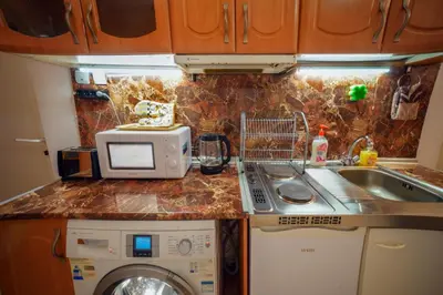 a kitchen with a sink and a washing machine at Central Halls apartment in Sofia