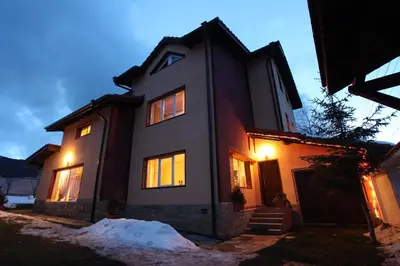 a house with its lights on in the snow at Ashkova House in Govedartsi