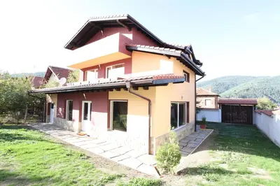 a house on a hill with a green yard at Ashkova House in Govedartsi