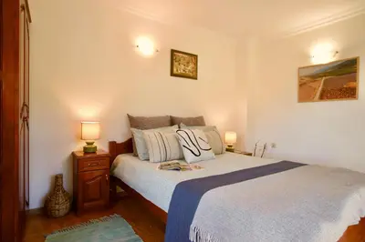 a bedroom with a bed with two lamps on it at Iliikova House in Kalofer