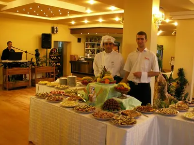 two chefs standing in front of a table of food at Dolna Bania Hotel in Dolna Banya