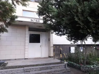 a building with a white door and a sign on it at Tulips - Room for travelers, close to the Airport, transport possible in Sofia