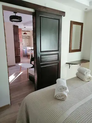 a bedroom with two white towels sitting on a bed at Апартамент Легал in Chepelare