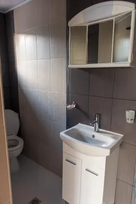 a bathroom with a sink and a toilet at Guest House Markovi in Govedartsi