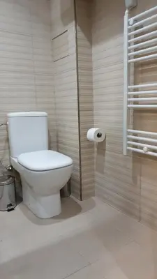 a bathroom with a toilet and a roll of toilet paper at IFM Boutique studio in Plovdiv