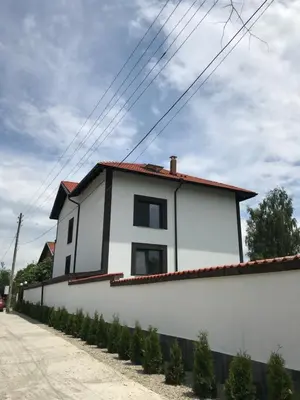 a white house with a red roof at КЪЩА ЗА ГОСТИ ХАРМОНИ in Shiroki Dol