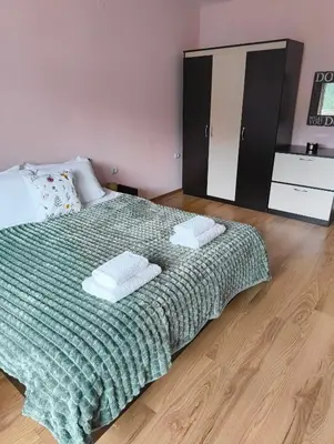 a bedroom with a bed with two pillows on it at Evrika home 5 in Pamporovo