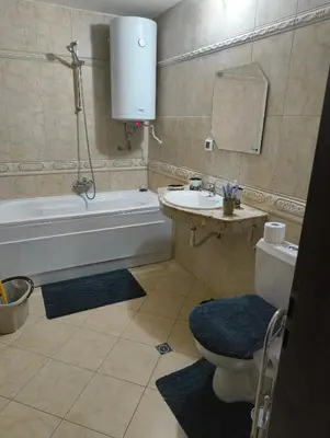 a bathroom with a tub and a toilet and a sink at Evrika home 21 in Pamporovo