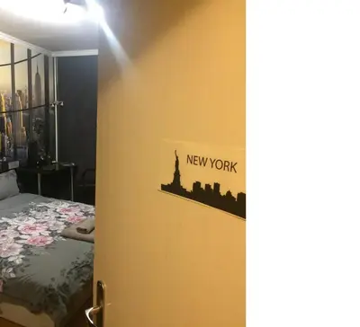a bedroom with a new work sign on the wall at New York - Room for overnight travelers near the Airport, parking in Sofia