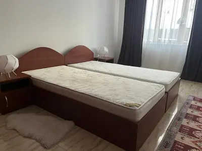 a bed with a wooden headboard in a bedroom at Ski 'Inn Monastery 3 Ski-to-Door in Pamporovo