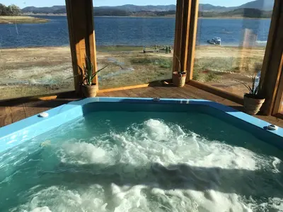 a jacuzzi tub with a view of the water at RELAX Guest House in Tsigov Chark