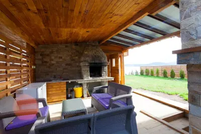 an outdoor patio with chairs and an outdoor oven at RELAX Guest House in Tsigov Chark
