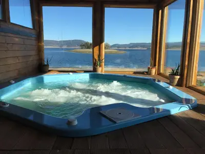 a jacuzzi tub with a view of the water at RELAX Guest House in Tsigov Chark