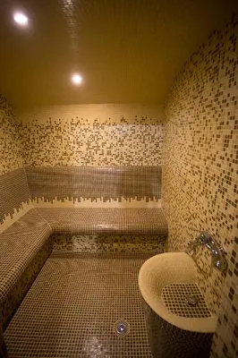 a bathroom with a tub and a sink at Family Prim Hotel in Sandanski