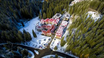 an aerial view of a large building in a forest at Pamporovo Apartment 314 The Castle 3 in Pamporovo