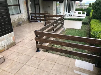 two wooden benches sitting outside of a building at ASPEN GOLF RESORT K004 Ski & Spa RELAX APARTMENT in Razlog