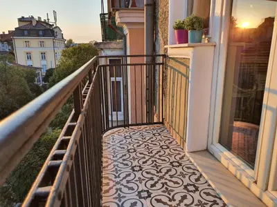 a balcony with a tile floor and a railing at Apartment Memoir by SofiaSpot - central, metro to airport in Sofia