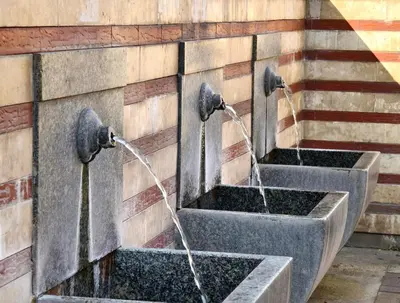 two water fountains on the side of a building at Apartment Memoir by SofiaSpot - central, metro to airport in Sofia
