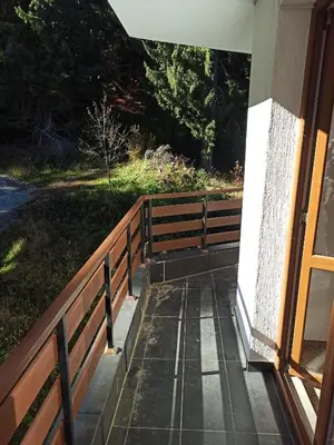 a porch of a house with a wooden fence at Private Apartments Nevena in Pamporovo