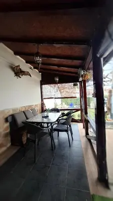a dining room with a table and chairs in a room at Стаи за гости Върбите in Sapareva Banya