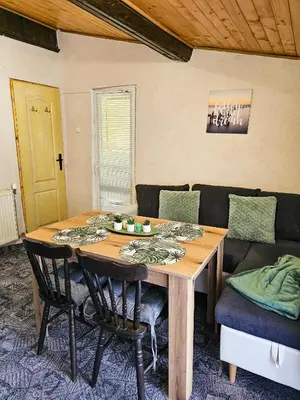 a dining room table with chairs and a couch at Guest Rooms- KLEPALSKI House in Borovets